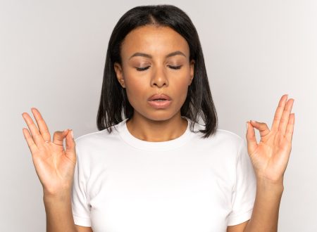 Stressed african woman holding hands in yoga gesture manage stress breathing deeply with closed eyes